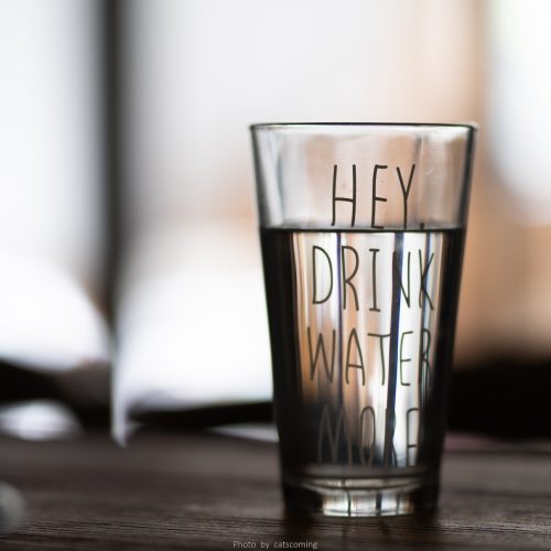 Can I drink the water in the Dominican Republic | Decorative Image of a glass of water that has "Hey, Drink More Water" written on the glass.