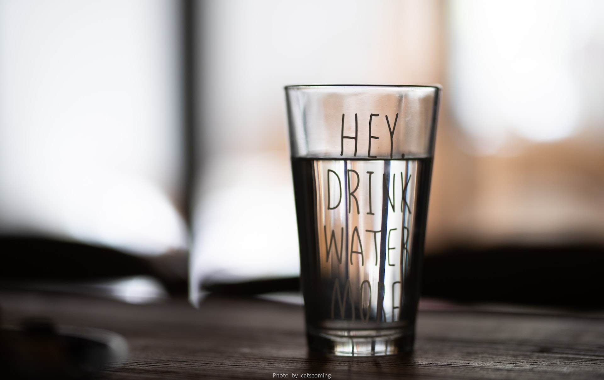 Can I drink the water in the Dominican Republic | Decorative Image of a glass of water that has "Hey, Drink More Water" written on the glass.